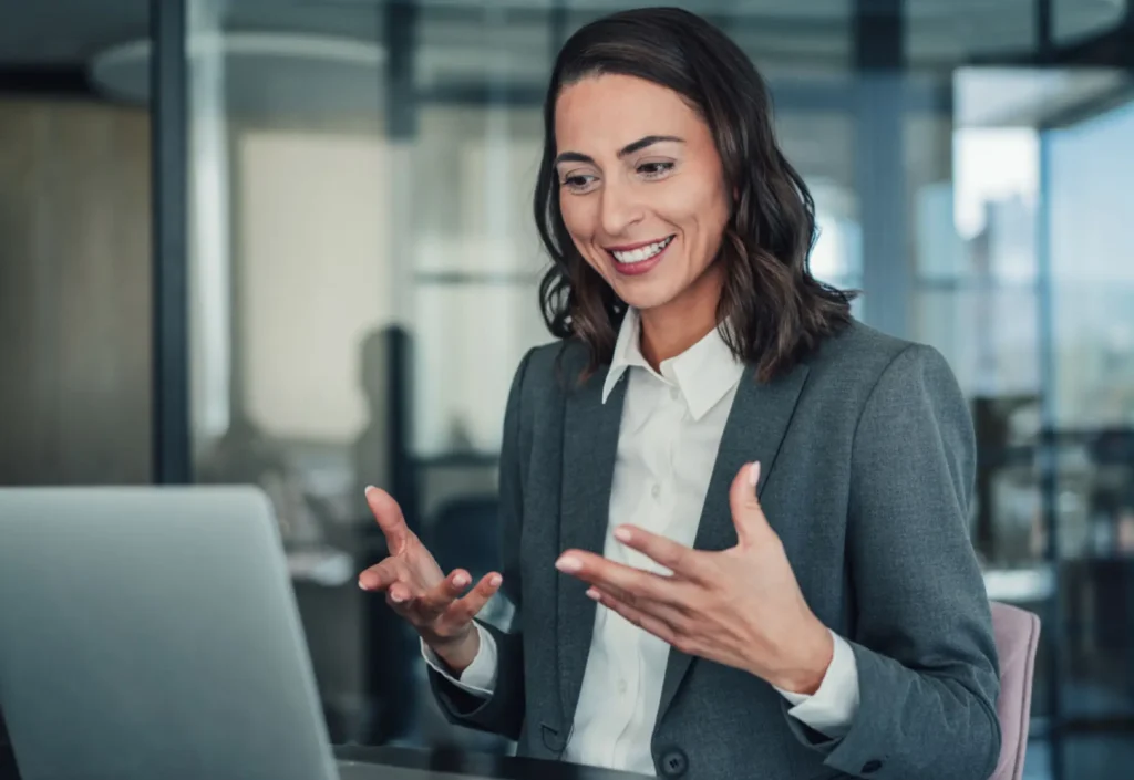 Businesswoman smiling and gesturing during a video call.